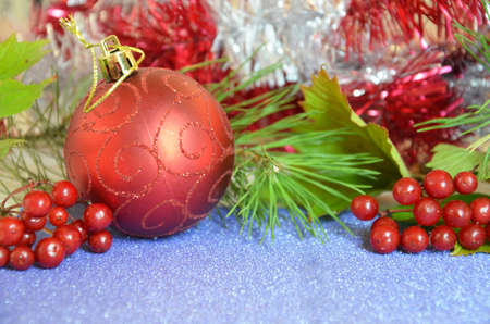 Christmas composition. Christmas gift, pine cones, fir branches on on a shimmering blue background, boke background. Flat lay, top view, copy spaceの写真素材