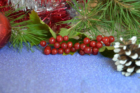 Christmas composition. Christmas gift, pine cones, fir branches on on a shimmering blue background, boke background. Flat lay, top view, copy spaceの写真素材