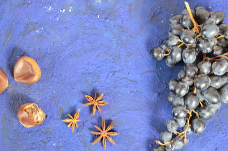 Autumn harvest, grapes, autumn fallen leaves, apples, plums, cinnamon, anise. wild grapes in autumn in the rainの写真素材