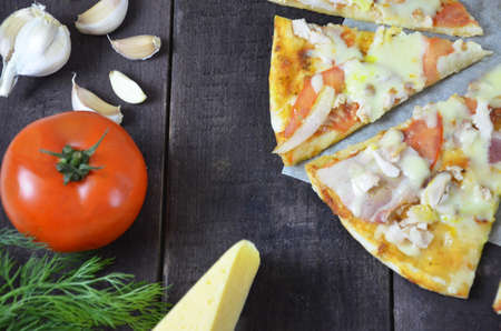 Pizza salami cheese ham. Hot Homemade Pepperoni Pizza Ready to Eat . with ingredients for cooking, greens, garlic, tomato. cheese and olive oilの写真素材