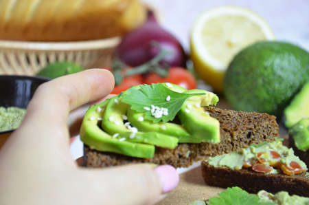 Guacamole and bread. Toast with avocado on white background. Homemade Mexican healthy vegan foodの写真素材