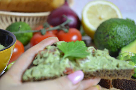 Guacamole and bread. Toast with avocado on white background. Homemade Mexican healthy vegan foodの写真素材
