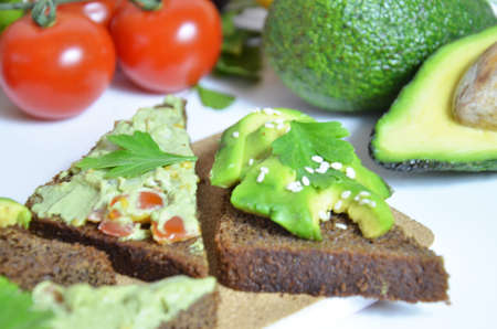 Guacamole and bread. Toast with avocado on white background. Homemade Mexican healthy vegan foodの写真素材