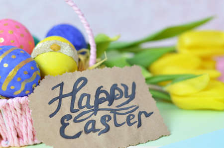 Easter eggs lying in a basket. Inscription Happy Easter. Space for text. Selected focus.