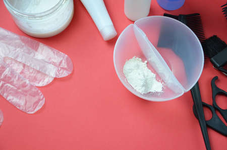 Barber shop set with hair dye, hairbrush, scissors, spray and brush on pink red background.の写真素材