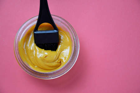 Barber shop set with hair dye, hairbrush, scissors, spray and brush on pink red background.の写真素材