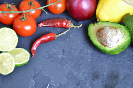 Set of traditional mexican dishes - burrito bowl, nachos, guacamole and salsa dressing, chili peppers, chopped jalapeño and lime on red background. Overhead view, flat lay, copy spaceの写真素材