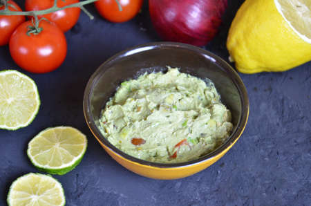 Mexican Guacamole in MolcajeteGuacamole prepared in a traditional volcanic stone bowl called molcajeteの写真素材