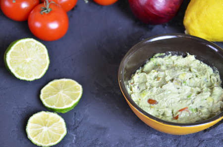 Mexican Guacamole in MolcajeteGuacamole prepared in a traditional volcanic stone bowl called molcajeteの写真素材