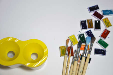 Paints and brushes on the white background.の写真素材