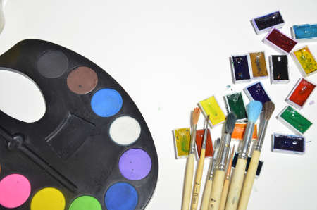 Paints and brushes on the white background.の写真素材