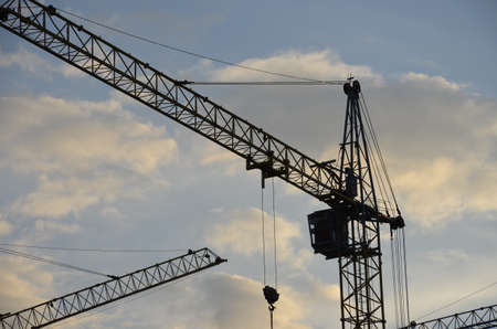 Construction crane near the building under construction. Close up of a construction crane. Self-erection crane. Construction siteの写真素材