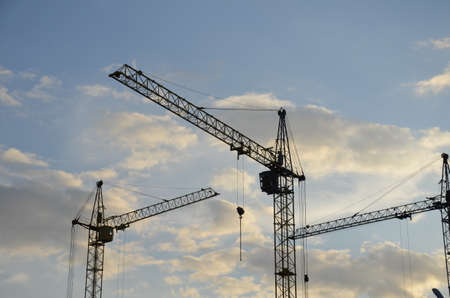Construction crane near the building under construction. Close up of a construction crane. Self-erection crane. Construction siteの写真素材