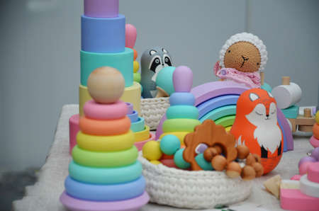 wooden toys for newborns. pyramid cups, balls, beads. Top view on multicolor toy bricks on white...