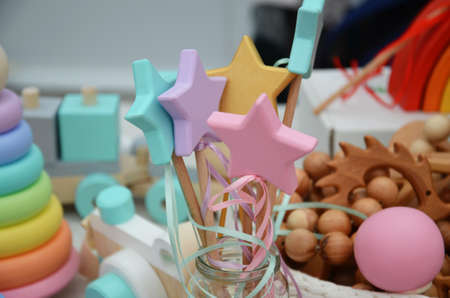 wooden toys for newborns. pyramid cups, balls, beads. Top view on multicolor toy bricks on white wooden background. Children toys on the tableの写真素材