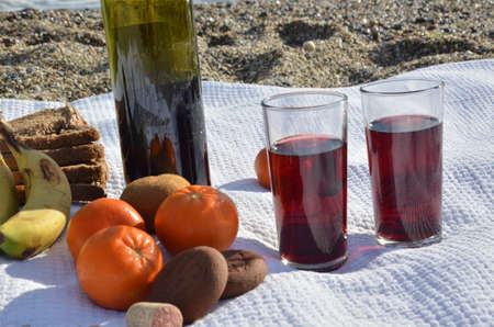A party on the beach at sunset with wine. Romantic day evening in the summer by the sea. Picnic. copy space,の写真素材