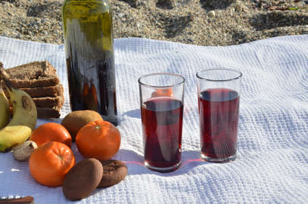 A party on the beach at sunset with wine. Romantic day evening in the summer by the sea. Picnic. copy space,の写真素材