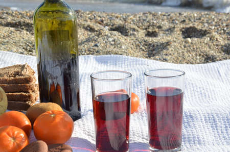 A party on the beach at sunset with wine. Romantic day evening in the summer by the sea. Picnic. copy space,の写真素材
