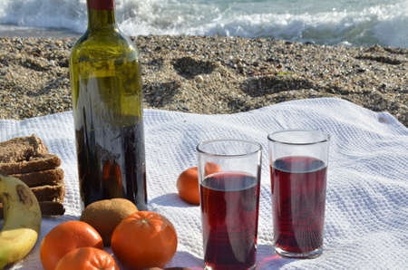 A party on the beach at sunset with wine. Romantic day evening in the summer by the sea. Picnic. copy space,の写真素材