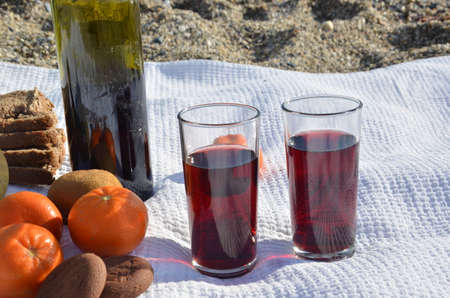 A party on the beach at sunset with wine. Romantic day evening in the summer by the sea. Picnic. copy space,の写真素材