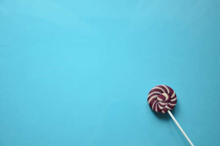 An assortment of colourful, festive sweets, blue marmalade in the shape of a heart on a blue background with a variety of caramels and candies, marshmallows. Abstract background. top view copy space.の写真素材