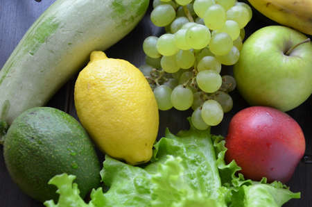 Healthy food clean eating selection: fruit, vegetable, seeds, superfood, cereal, leaf vegetable on gray concrete backgroundの写真素材