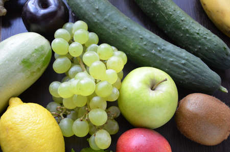 Healthy food clean eating selection: fruit, vegetable, seeds, superfood, cereal, leaf vegetable on gray concrete backgroundの写真素材