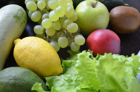 Healthy food clean eating selection: fruit, vegetable, seeds, superfood, cereal, leaf vegetable on gray concrete backgroundの写真素材