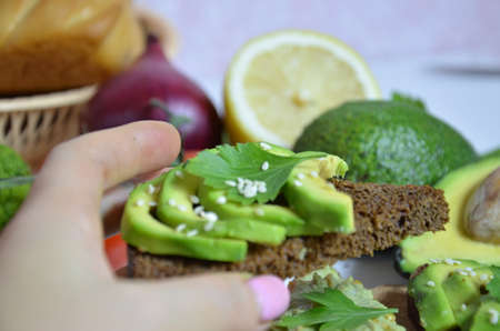 Guacamole and bread. Toast with avocado on white background. Homemade Mexican healthy vegan foodの写真素材