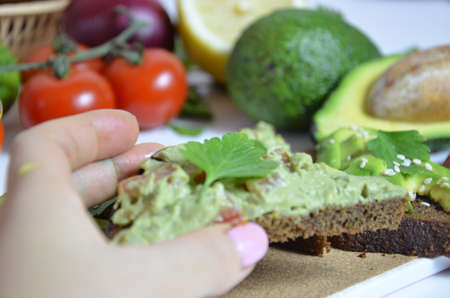 Guacamole and bread. Toast with avocado on white background. Homemade Mexican healthy vegan foodの写真素材