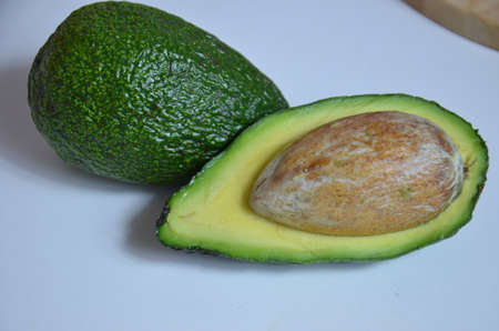 Natural organic ripe avocado. Half avocado on white background. Isolated. Top view.の写真素材