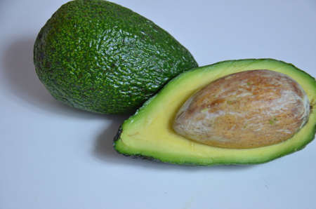 Natural organic ripe avocado. Half avocado on white background. Isolated. Top view.の写真素材