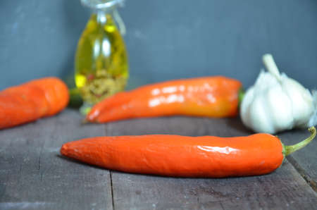 Red hot chili peppers and garlic, on dark wooden background. copy space top viewの写真素材