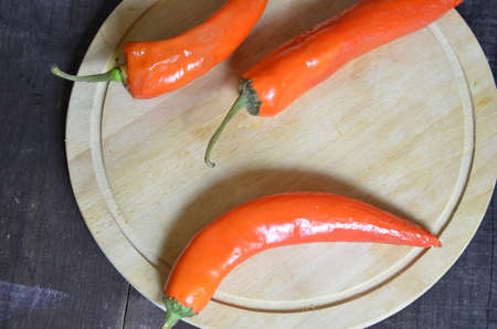 red hot chili pepper corns and pods on dark vintage background, top view.の写真素材
