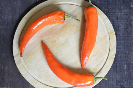 red hot chili pepper corns and pods on dark vintage background, top view.の写真素材