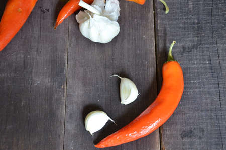 Red hot chili peppers and garlic, on dark wooden background. copy space top viewの写真素材