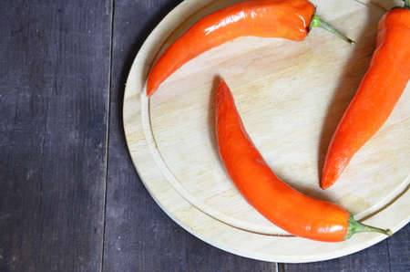 red hot chili pepper corns and pods on dark vintage background, top view.の写真素材