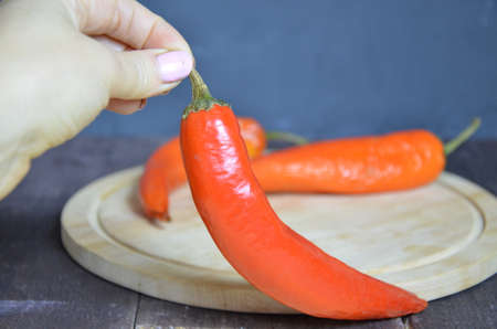 red hot chili pepper corns and pods on dark vintage background, top view.の写真素材