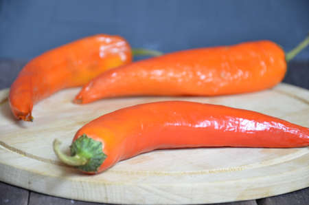 red hot chili pepper corns and pods on dark vintage background, top view.の写真素材
