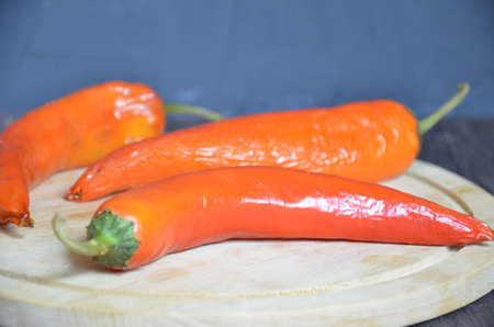red hot chili pepper corns and pods on dark vintage background, top view.の写真素材