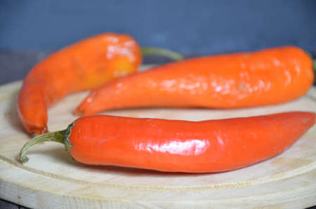 red hot chili pepper corns and pods on dark vintage background, top view.の写真素材