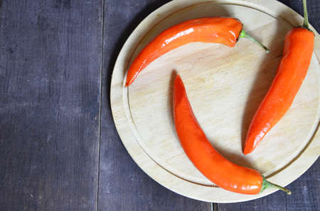 red hot chili pepper corns and pods on dark vintage background, top view.の写真素材