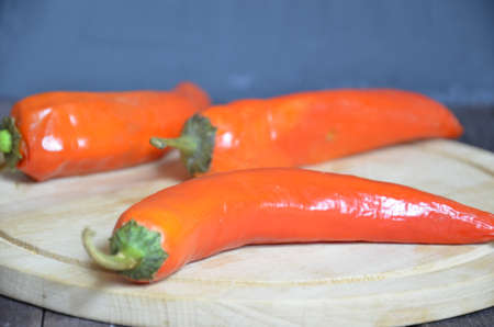 red hot chili pepper corns and pods on dark vintage background, top view.の写真素材