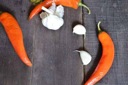 Red hot chili peppers and garlic, on dark wooden background. copy space top viewの写真素材