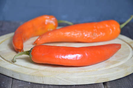 red hot chili pepper corns and pods on dark vintage background, top view.の写真素材