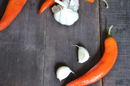 Red hot chili peppers and garlic, on dark wooden background. copy space top viewの写真素材
