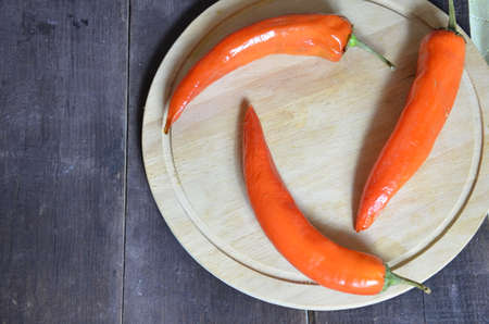 red hot chili pepper corns and pods on dark vintage background, top view.の写真素材