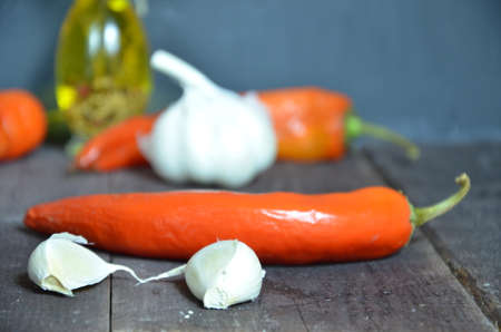 Red hot chili peppers and garlic, on dark wooden background. copy space top viewの写真素材