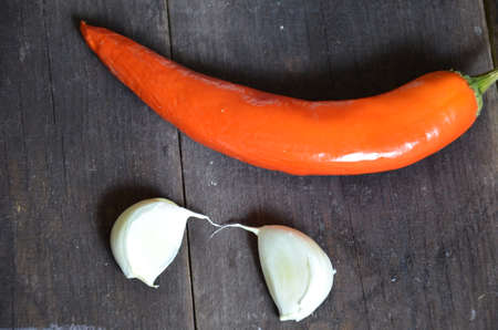 Red hot chili peppers and garlic, on dark wooden background. copy space top viewの写真素材