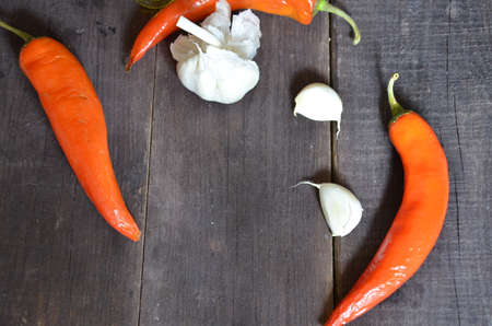 Red hot chili peppers and garlic, on dark wooden background. copy space top viewの写真素材